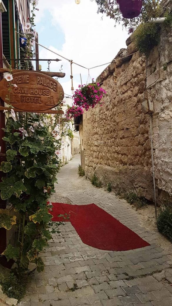 narrow street at Goreme, Cappadocia with red carpet