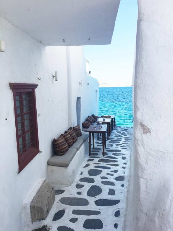 white narrow street by the sea at mykonos
