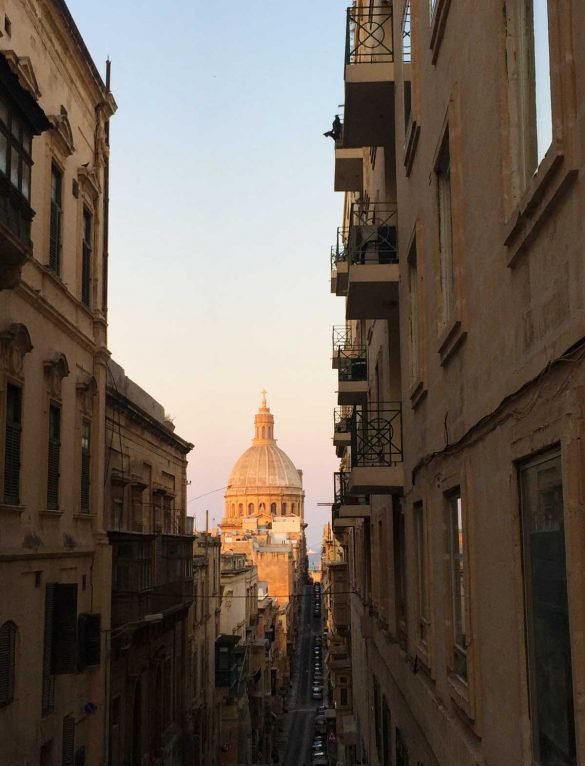 narrow street in Valletta with cathedral