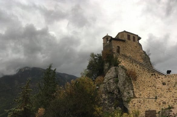 christian church over a rock with a staircase leading to it