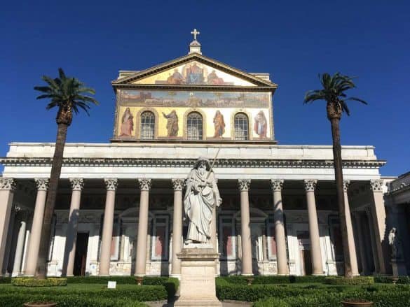 ancient papal major basilica with a statue in a garden