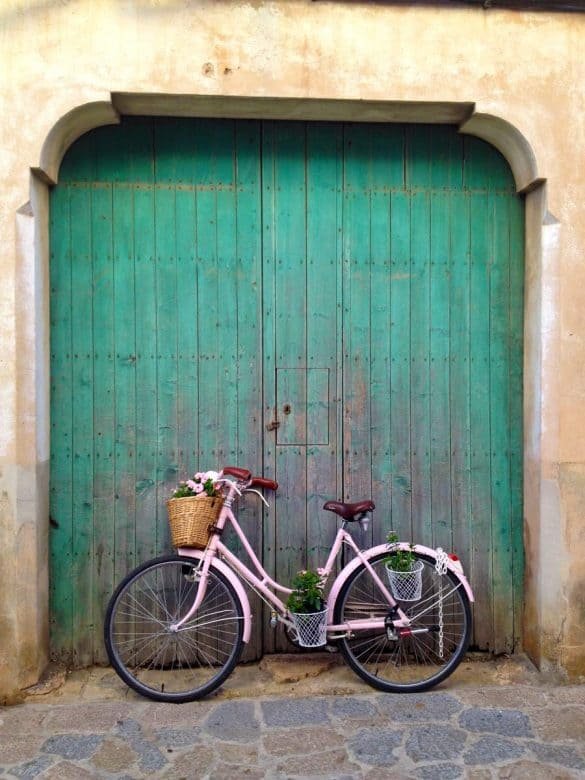 Alcudia – Majorca, Balearic Islands picturesque green door with a pink bicycle in majorca