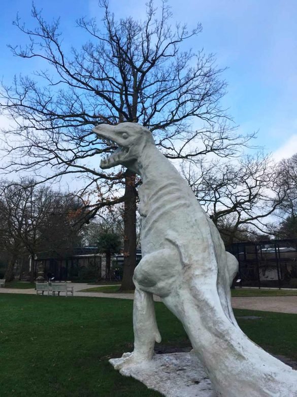 plaster statue of t-rex dinosaur standing still