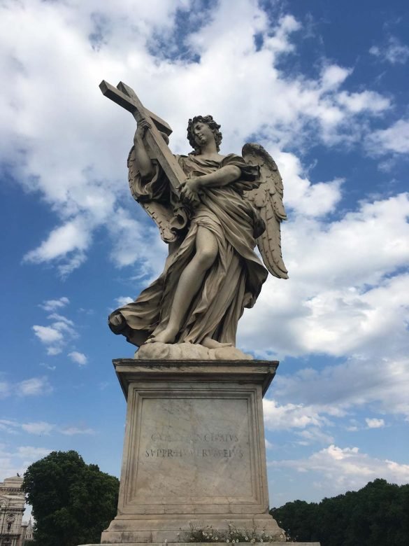 a statue of an angel holding a cross at castel santangelo in rome