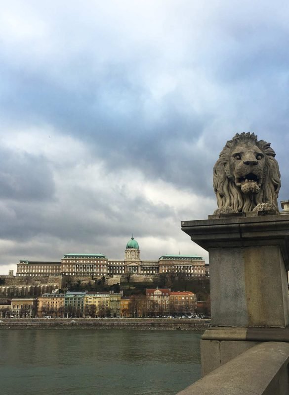 a stone statue of a lion on bridge