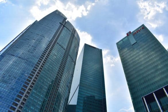 photos of three glass skyscrapers taken from the bottom on singapore downtown