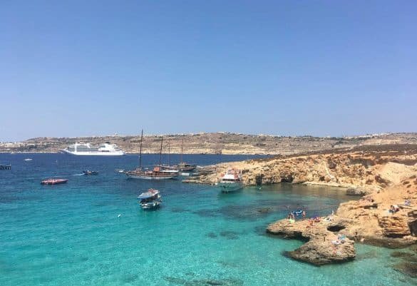 turquoise water at blue lagoon, comino with boats