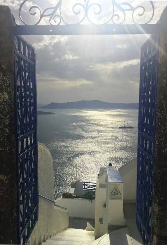 Caldera view through a blue door at Santorini Island, Greece