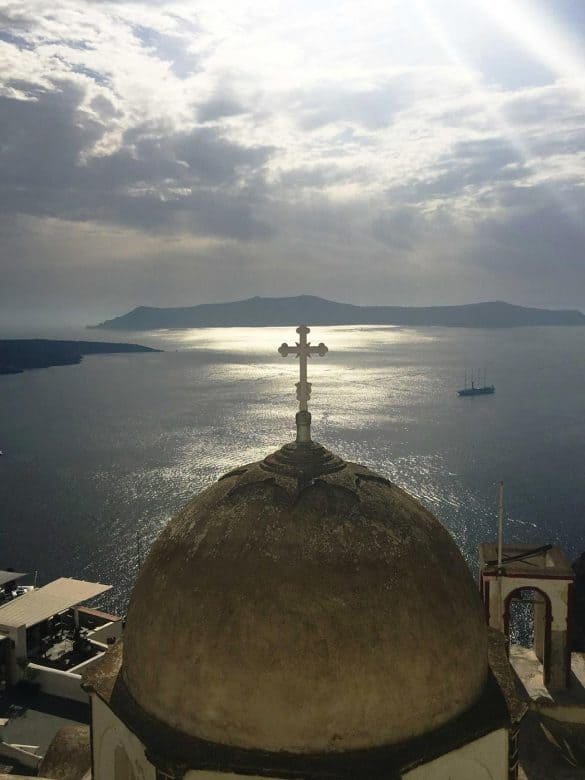 white church dome with the sea as background in santorini