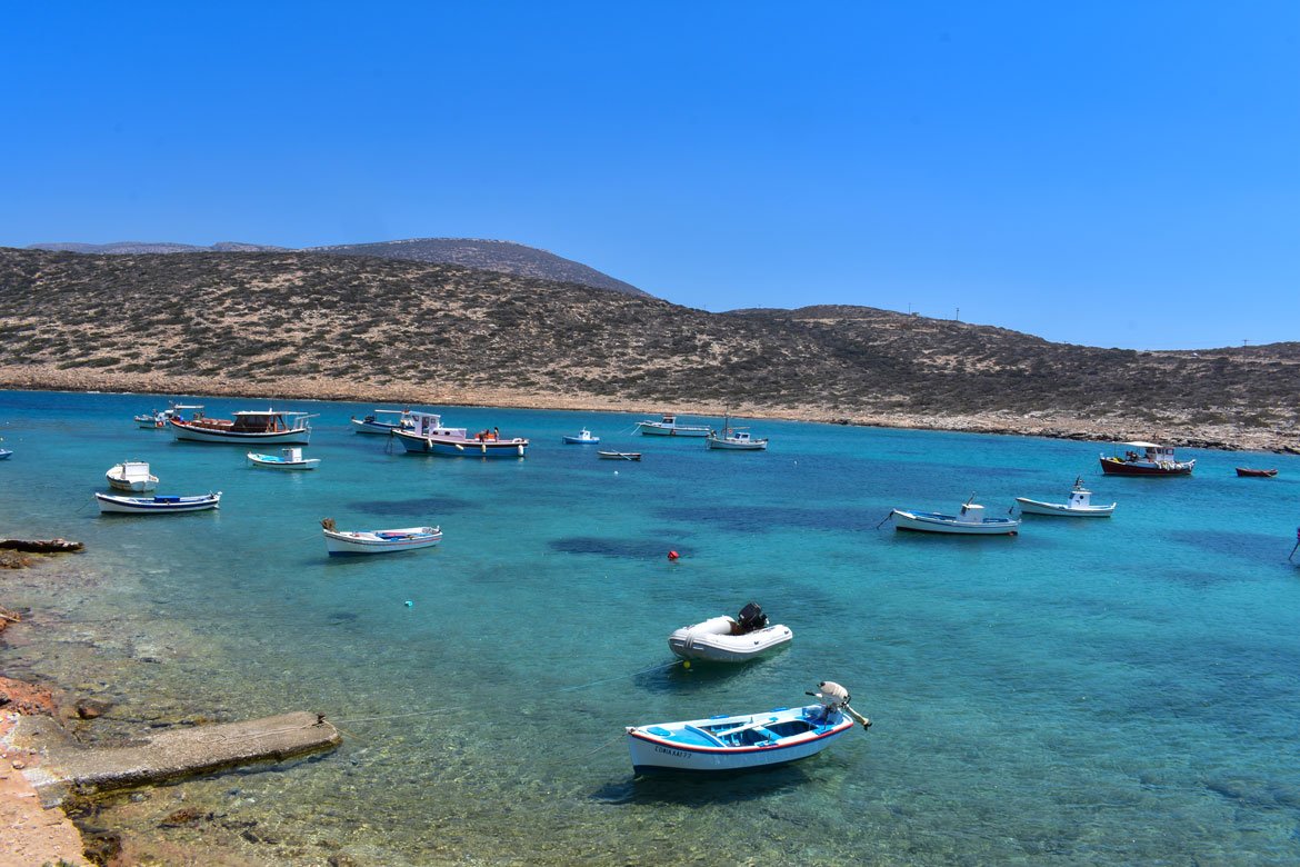 fishing boats in a sheltered bay with crystal waters